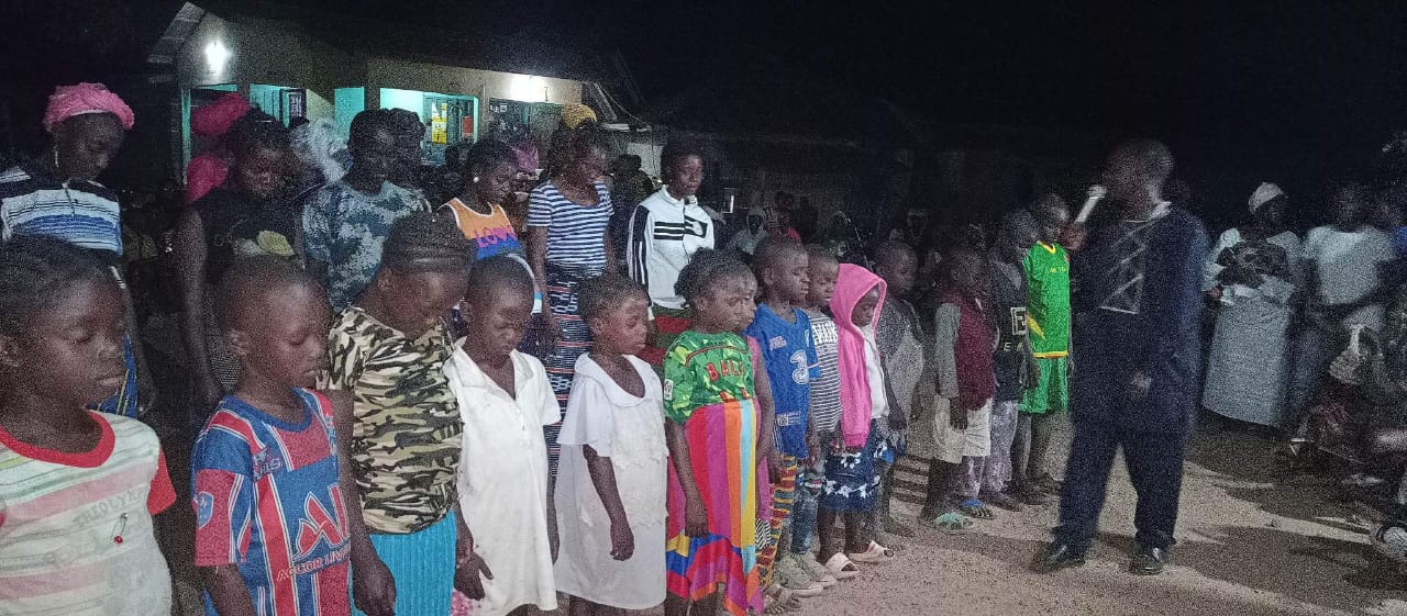 People standing in prayer during a crusade gathering