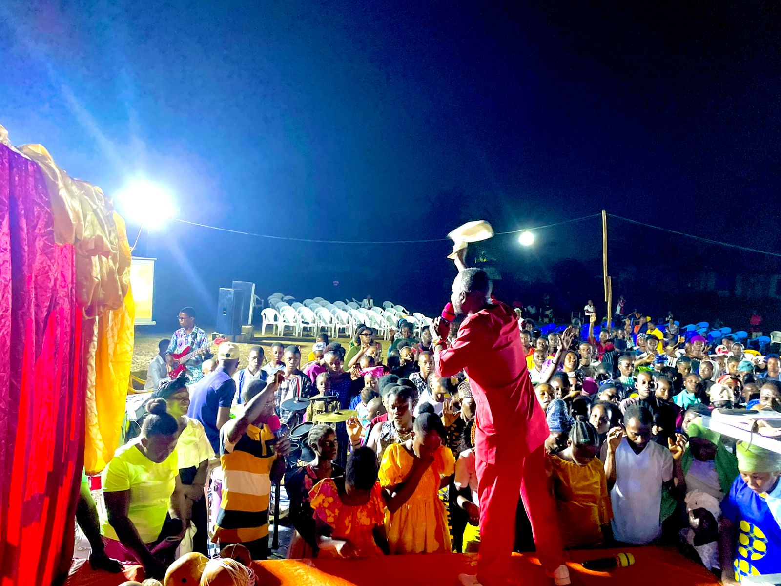 Open-air crusade audience listening to the gospel